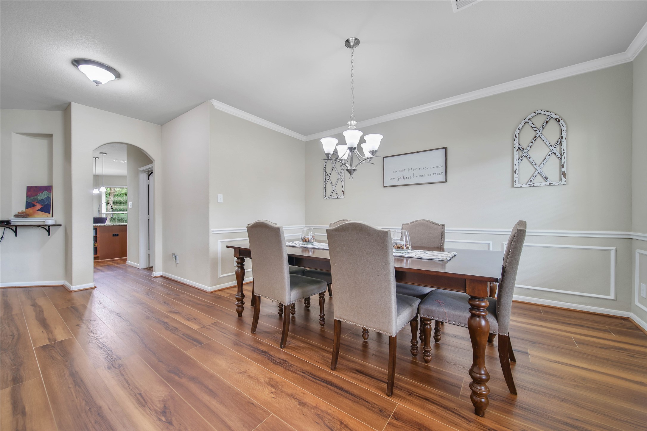 9223 Wapiti Trail Conroe, TX 77303 - Photo 9 of 45 a view of a dining room with furniture wooden floor and a chandelier
