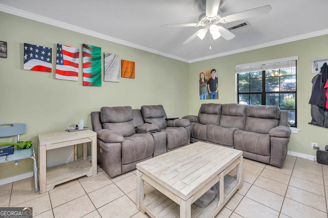 214 Island Drive St. Simons, GA 31522 - Photo 4 of 12 a living room with furniture and a window