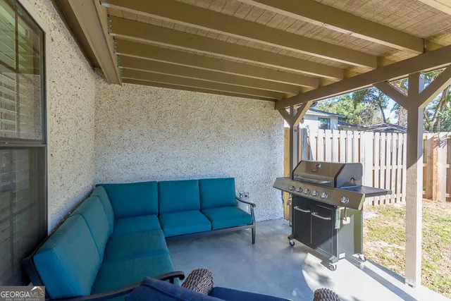 a view of backyard with furniture and wooden deck