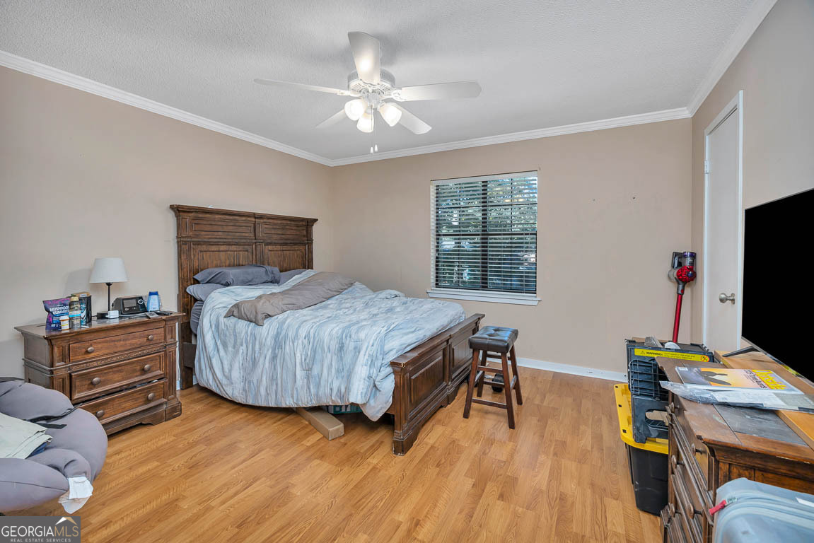 214 Island Drive St. Simons, GA 31522 - Photo 10 of 12 a bedroom with a bed and a flat screen tv