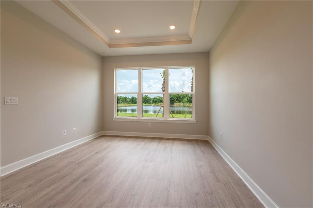 15633 Gavello Street Naples, FL 34114 - Photo 12 of 37 wooden floor in an empty room with a window