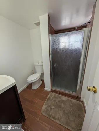 a bathroom with a toilet and a shower