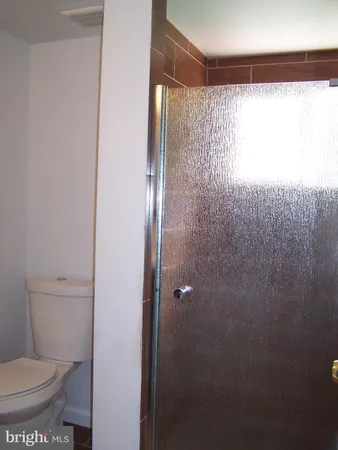 a bathroom with a toilet and a shower