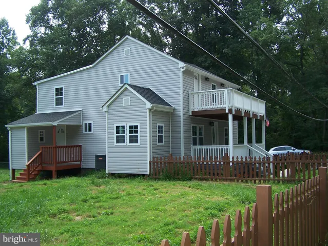 a front view of house with a garden