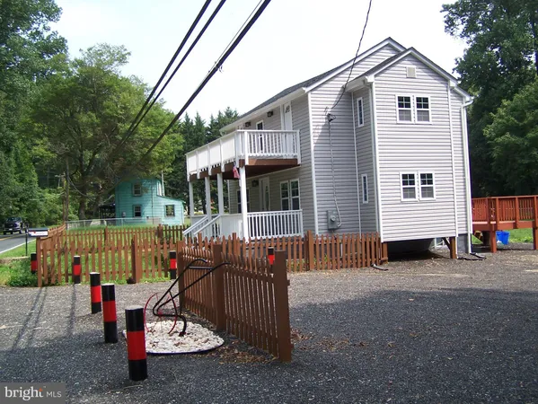 a view of a house with a patio and a yard