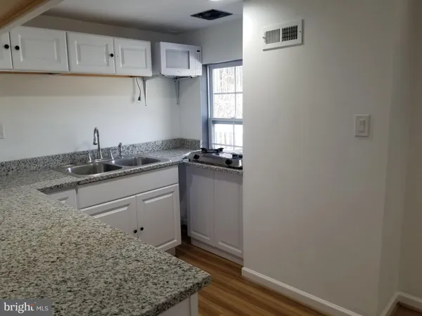 a kitchen with a sink and cabinets