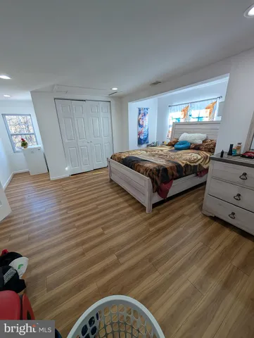 a spacious bedroom with a bed and window