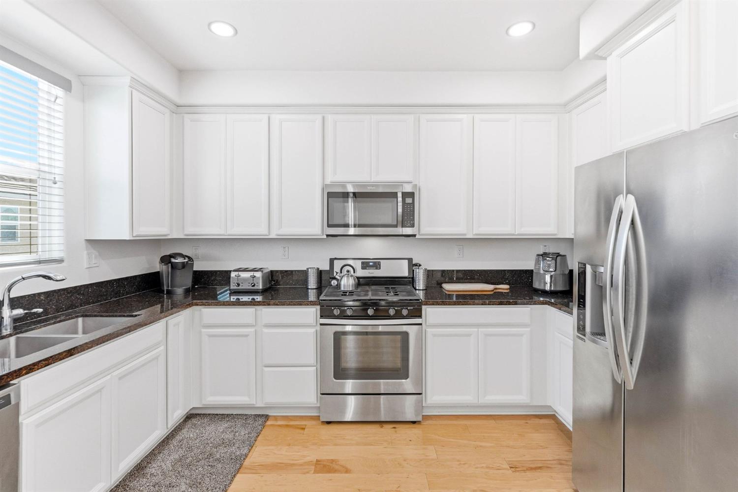2564 Prosper Road Sacramento, CA 95834 - Photo 17 of 46 a kitchen with a sink a stove and refrigerator