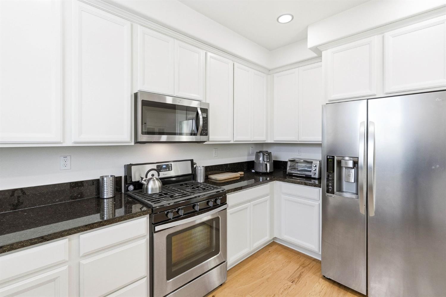 2564 Prosper Road Sacramento, CA 95834 - Photo 18 of 46 a kitchen with stainless steel appliances white cabinets and a refrigerator