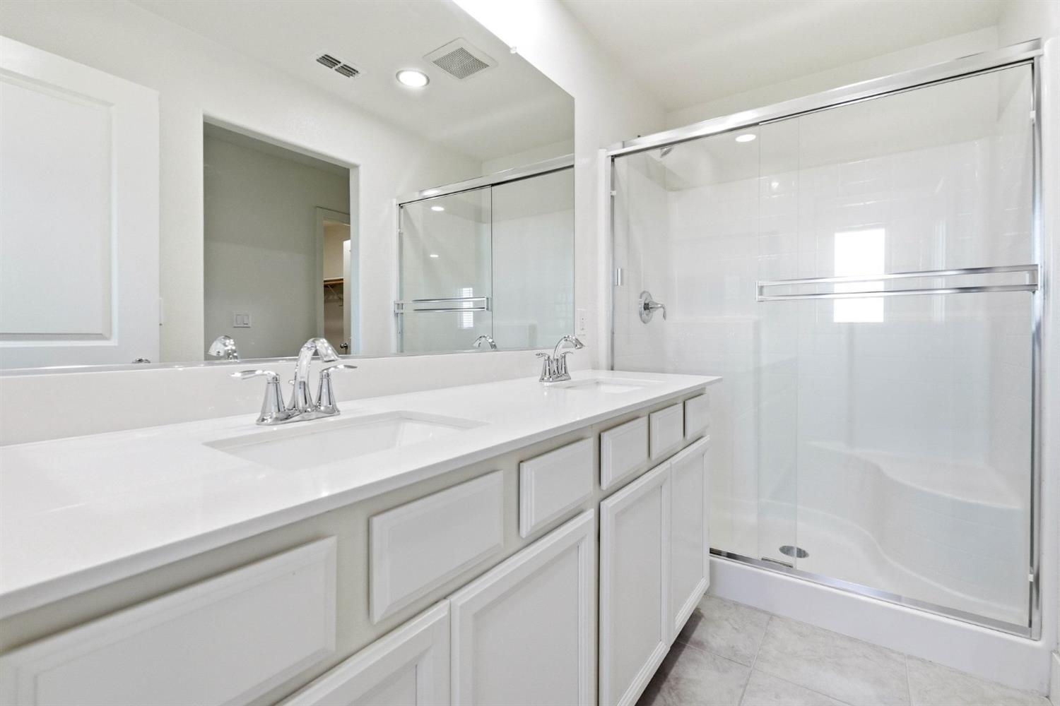 2564 Prosper Road Sacramento, CA 95834 - Photo 37 of 46 a bathroom with a shower sink vanity and mirror