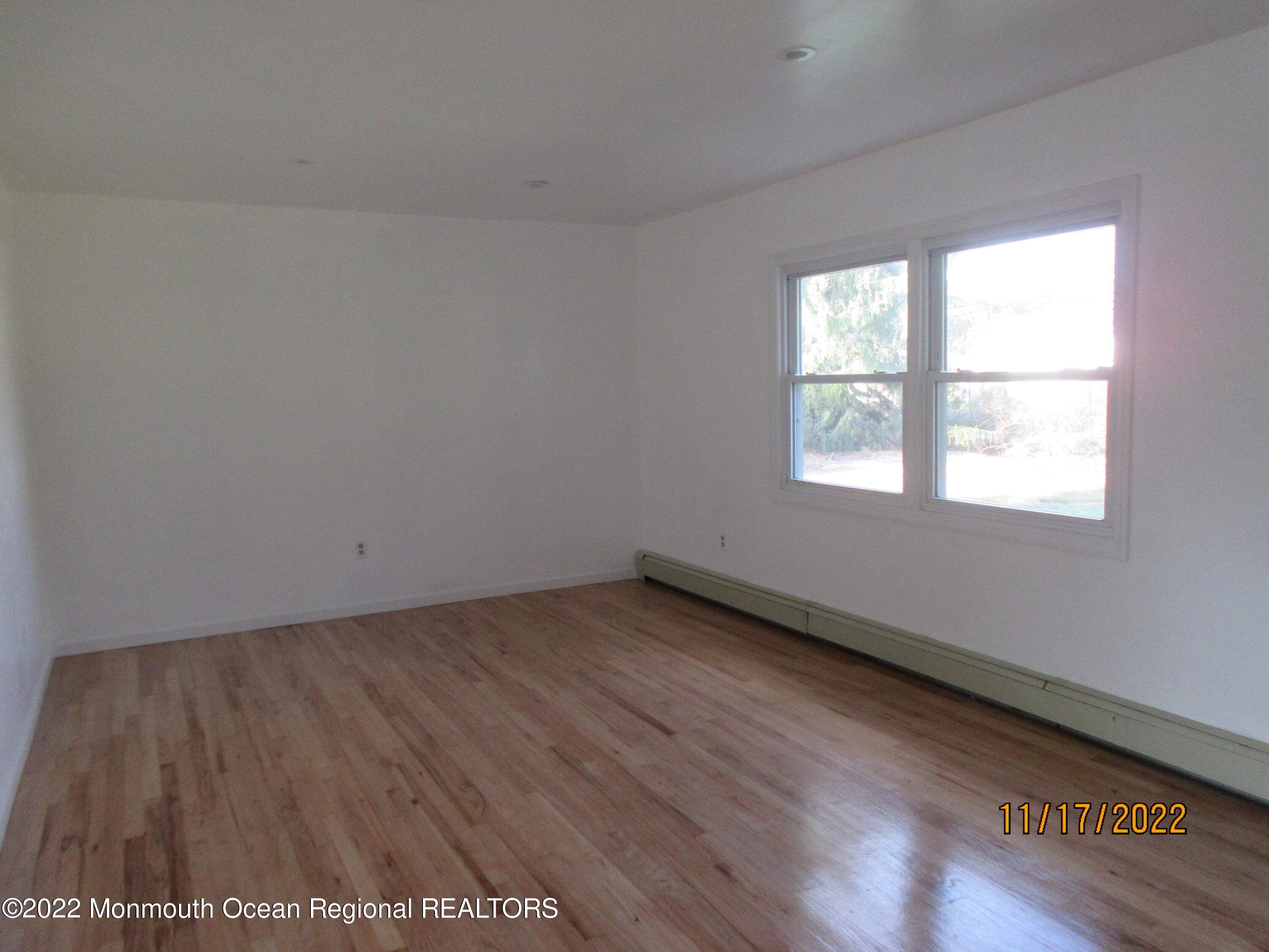 28 New Friendship Road Howell, NJ 07731 - Photo 15 of 29 an empty room with wooden floor and windows