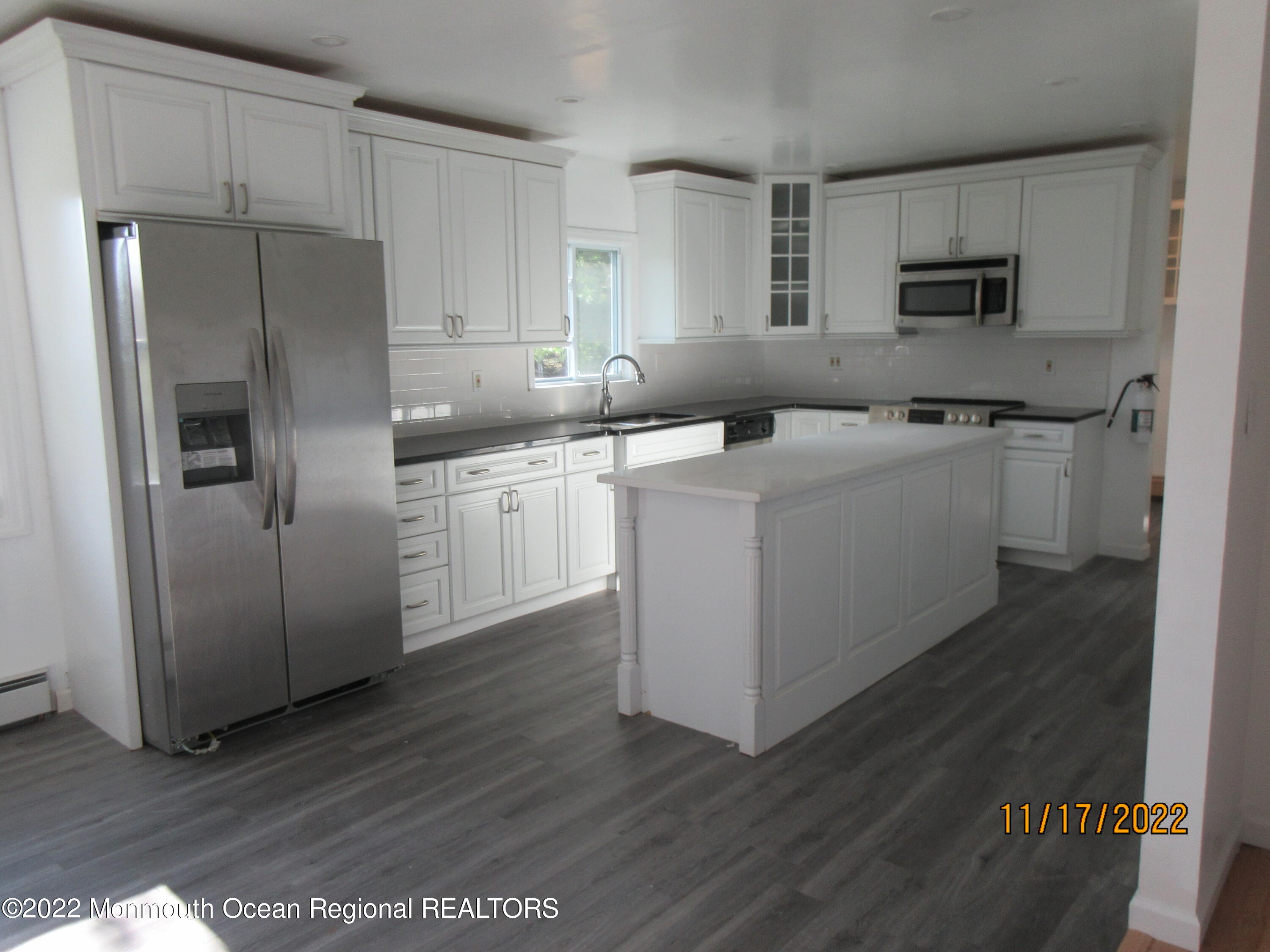 28 New Friendship Road Howell, NJ 07731 - Photo 6 of 29 a kitchen with stainless steel appliances a refrigerator stove microwave and sink