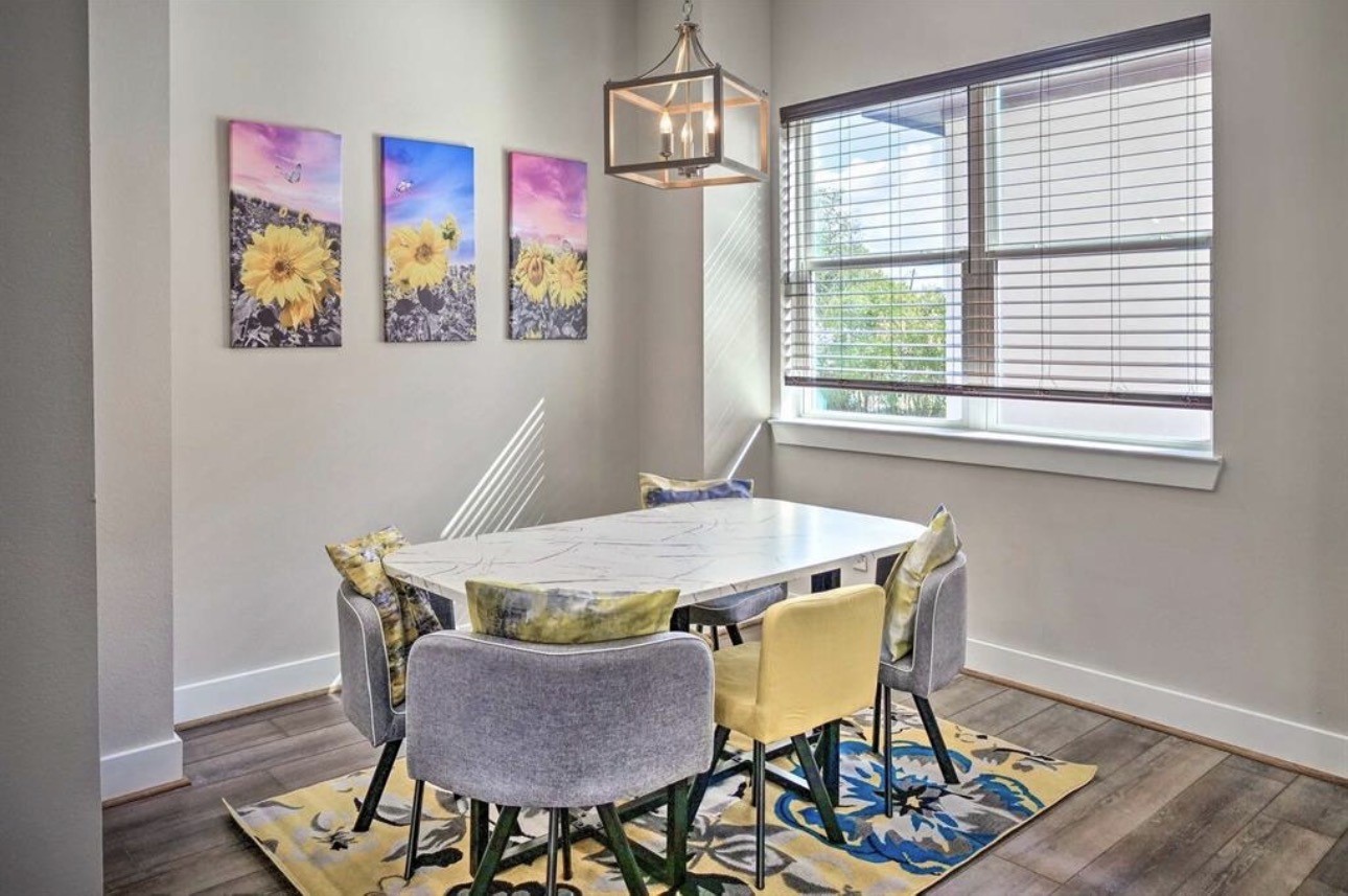 6403 Bowling Green Street Houston, TX 77021 - Photo 11 of 31 a view of a dining room with furniture a chandelier and wooden floor