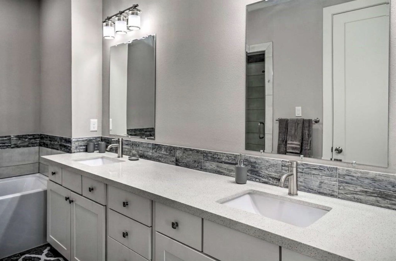6403 Bowling Green Street Houston, TX 77021 - Photo 16 of 31 a bathroom with double sink and a mirror