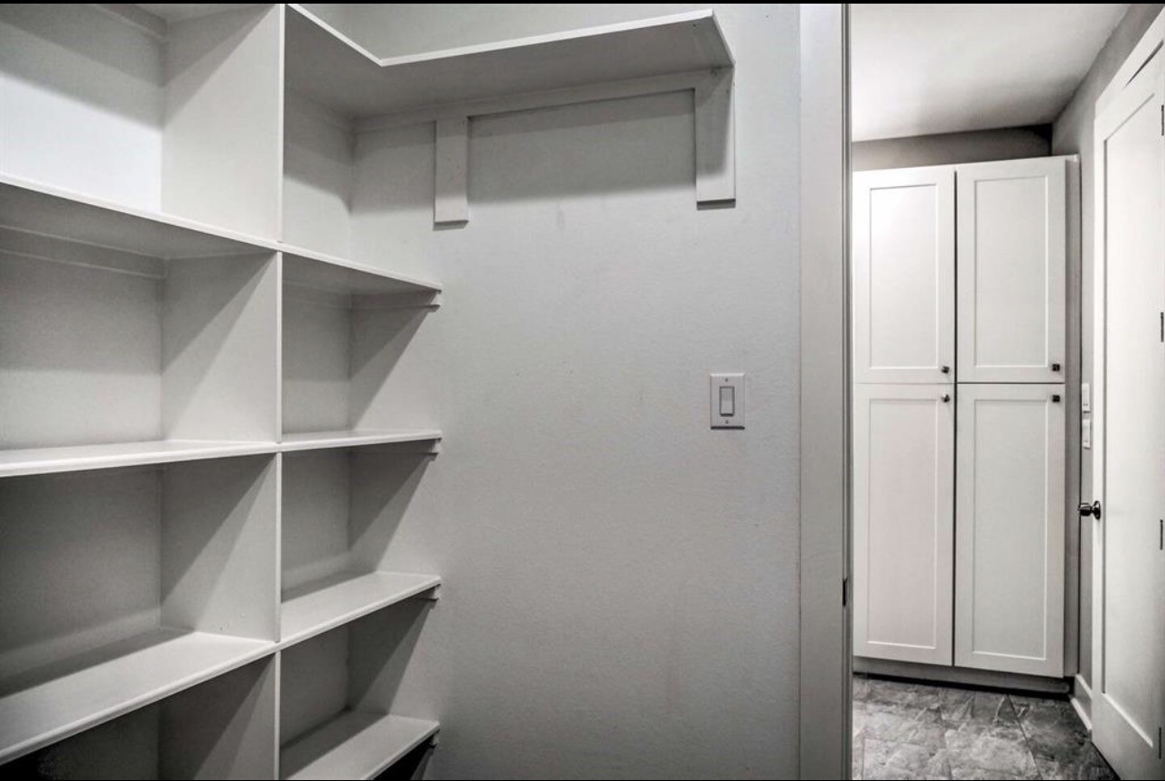 6403 Bowling Green Street Houston, TX 77021 - Photo 17 of 31 a view of walk in closet with empty racks