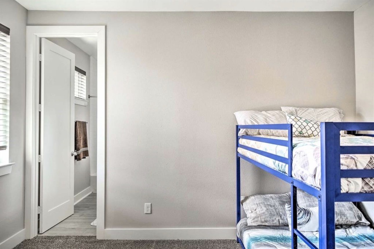 6403 Bowling Green Street Houston, TX 77021 - Photo 23 of 31 a bedroom with a bed and a mirror