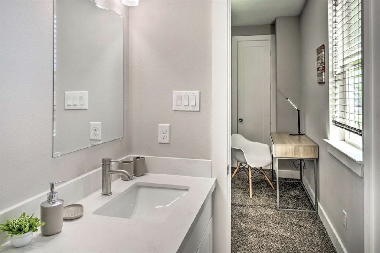 6403 Bowling Green Street Houston, TX 77021 - Photo 25 of 31 a bathroom with a sink and a large mirror