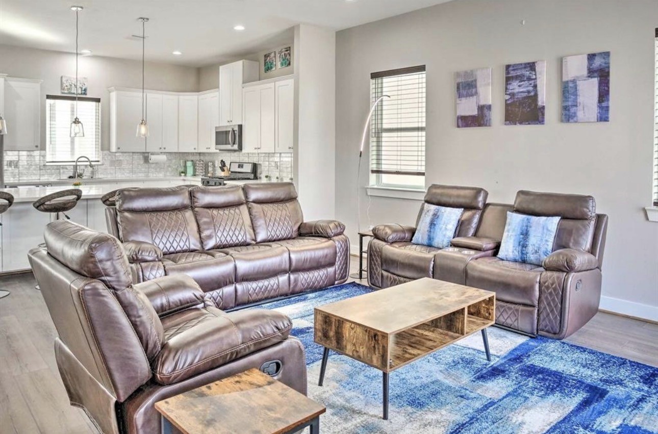6403 Bowling Green Street Houston, TX 77021 - Photo 5 of 31 a living room with furniture wooden floor and a kitchen view