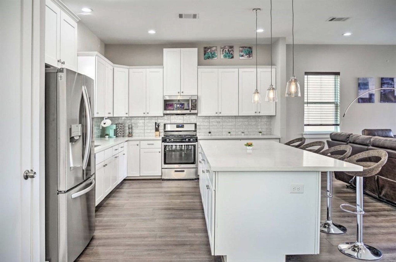 6403 Bowling Green Street Houston, TX 77021 - Photo 10 of 31 a kitchen with white cabinets and stainless steel appliances