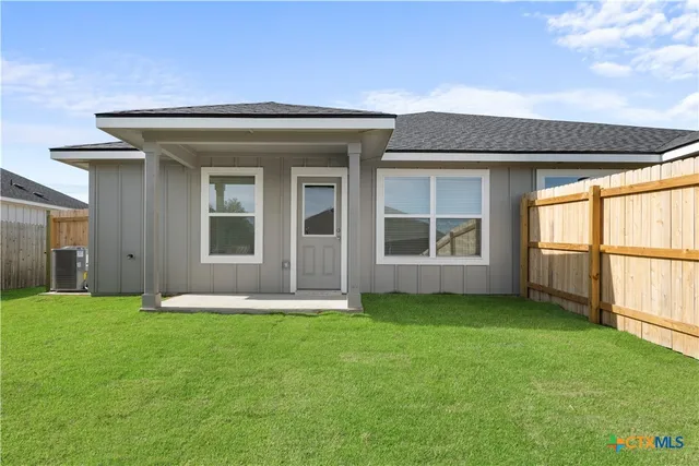 a picture of a room with a white wall and a large window