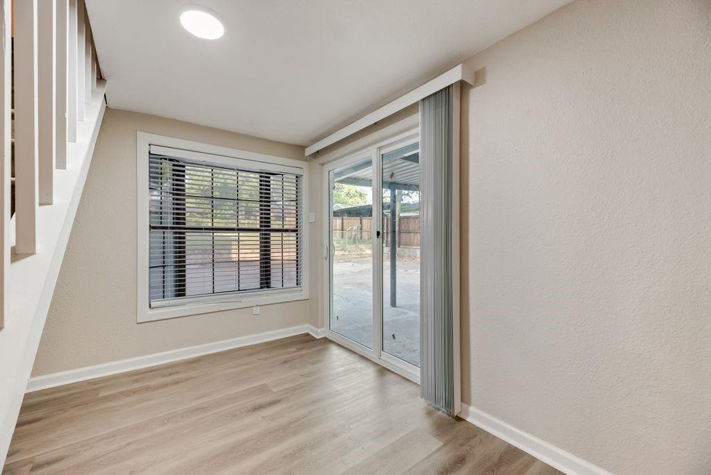 5706 Rocky Ridge Road Dallas, TX 75241 - Photo 9 of 31 an empty room with wooden floor and windows