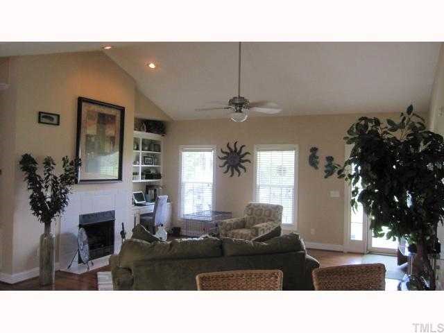 145 Sam Brummitt Road Henderson, NC 27537 - Photo 3 of 11 a living room with furniture a fireplace and a potted plant