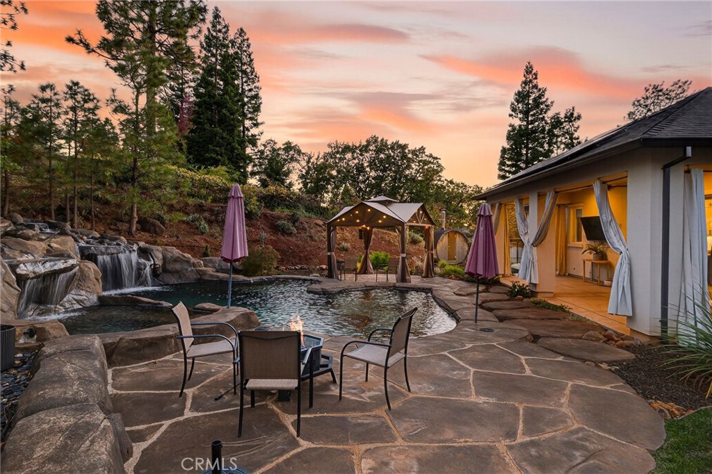 a backyard of a house with table and chairs