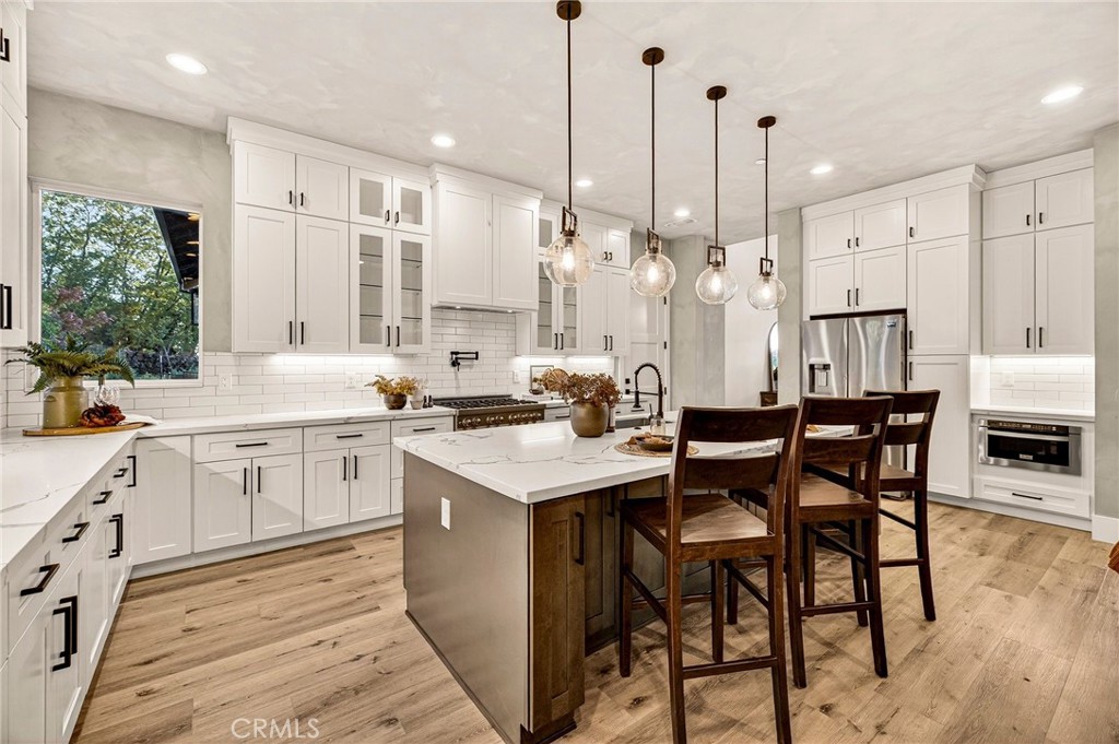 5772 Acorn Ridge Drive Paradise, CA 95969 - Photo 16 of 59 a kitchen with a table chairs stove and cabinets