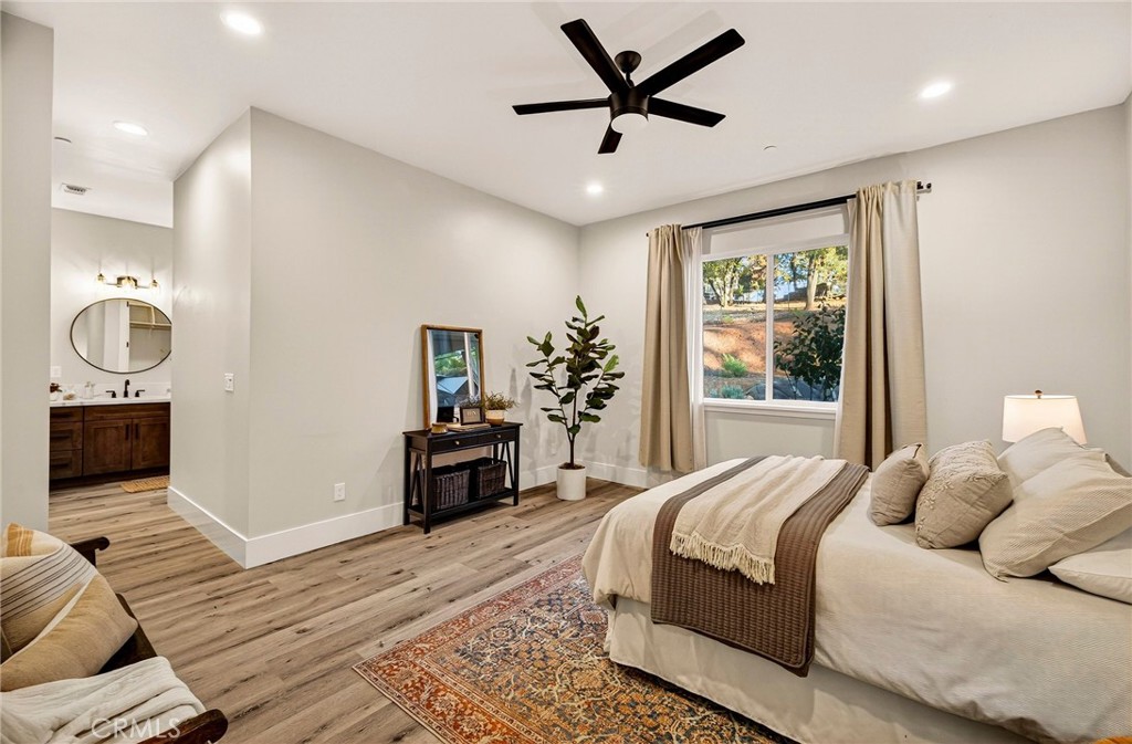5772 Acorn Ridge Drive Paradise, CA 95969 - Photo 26 of 59 a bedroom with a large bed and a chandelier