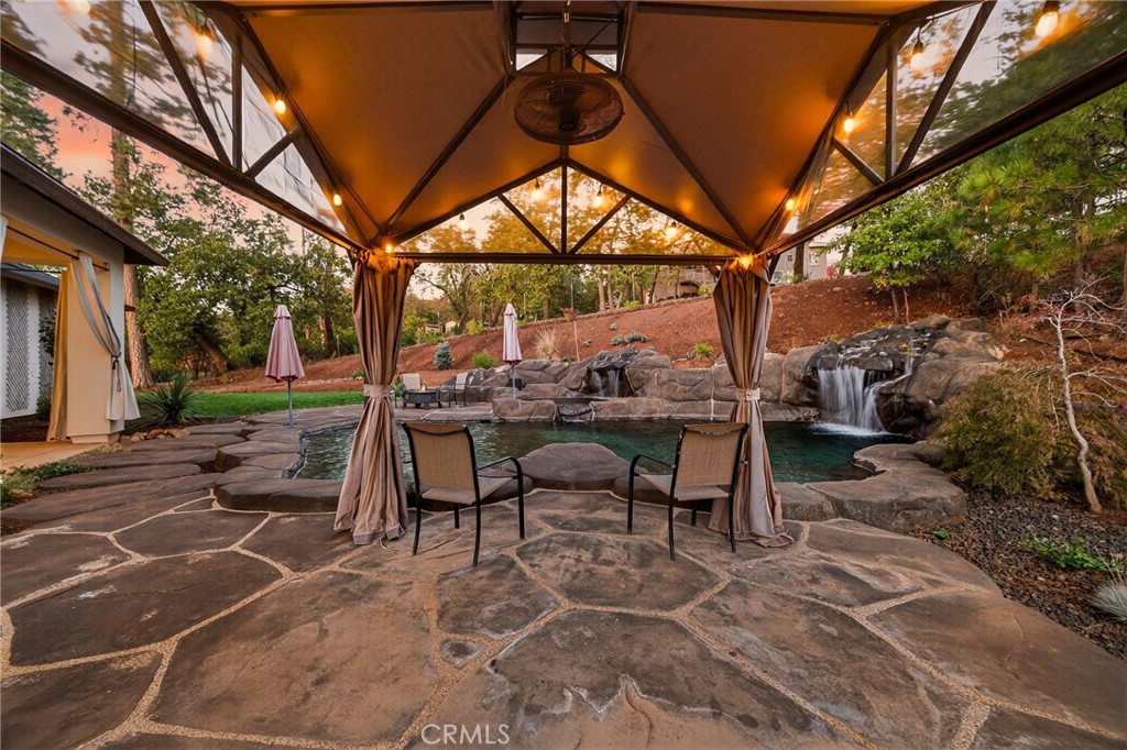 5772 Acorn Ridge Drive Paradise, CA 95969 - Photo 41 of 59 a view of a patio with table and chairs and floor to ceiling window