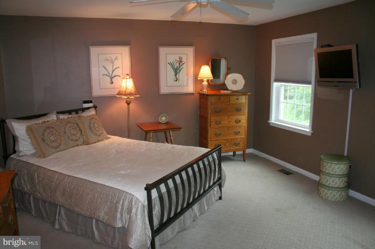 3005 Jackson Ridge Court Phoenix, MD 21131 - Photo 9 of 22 a bed sitting in a bedroom next to a window