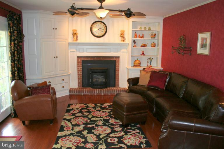 3005 Jackson Ridge Court Phoenix, MD 21131 - Photo 10 of 22 a living room with furniture and a fireplace