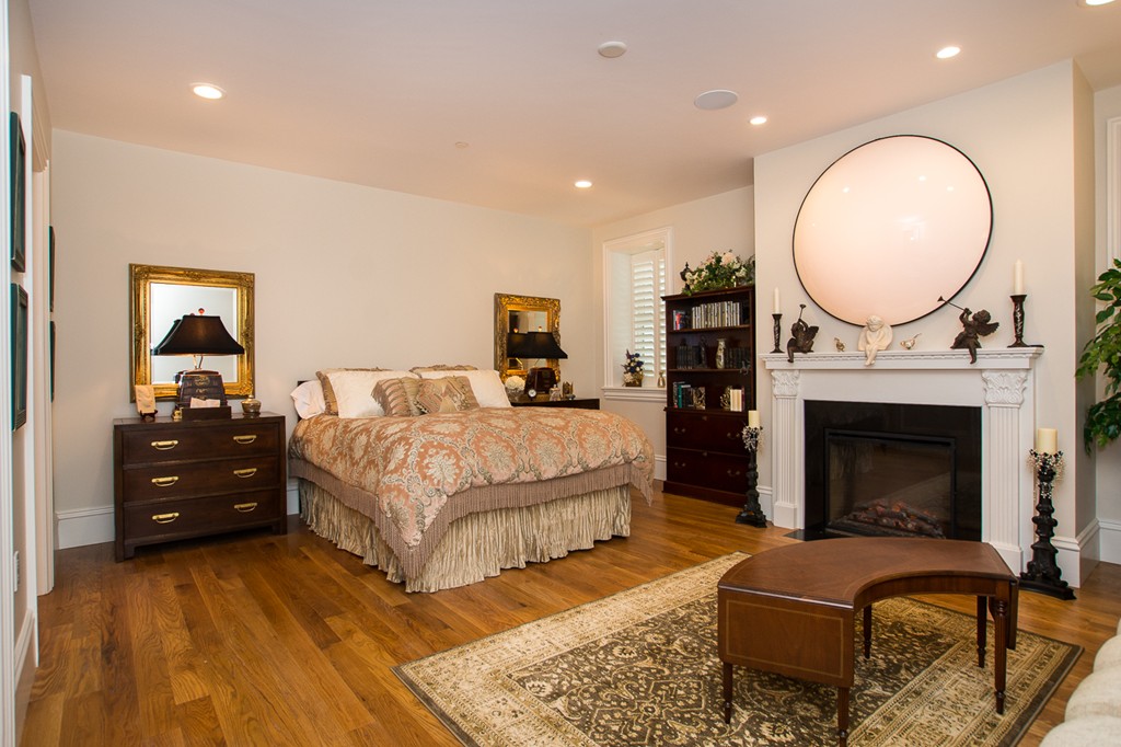 1 Winter Place, Unit 2 Boston, MA 02108 - Photo 12 of 17 a spacious bedroom with a bed a dresser and a fireplace