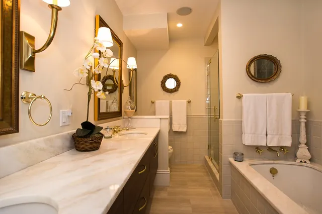 a bathroom with a tub sink and mirror on the wall