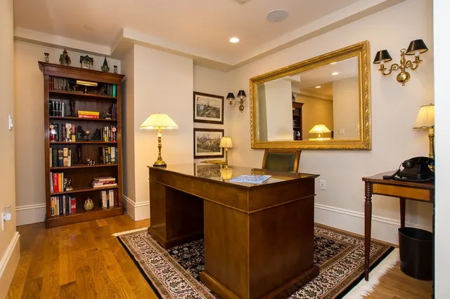 a living room with furniture and a book shelf