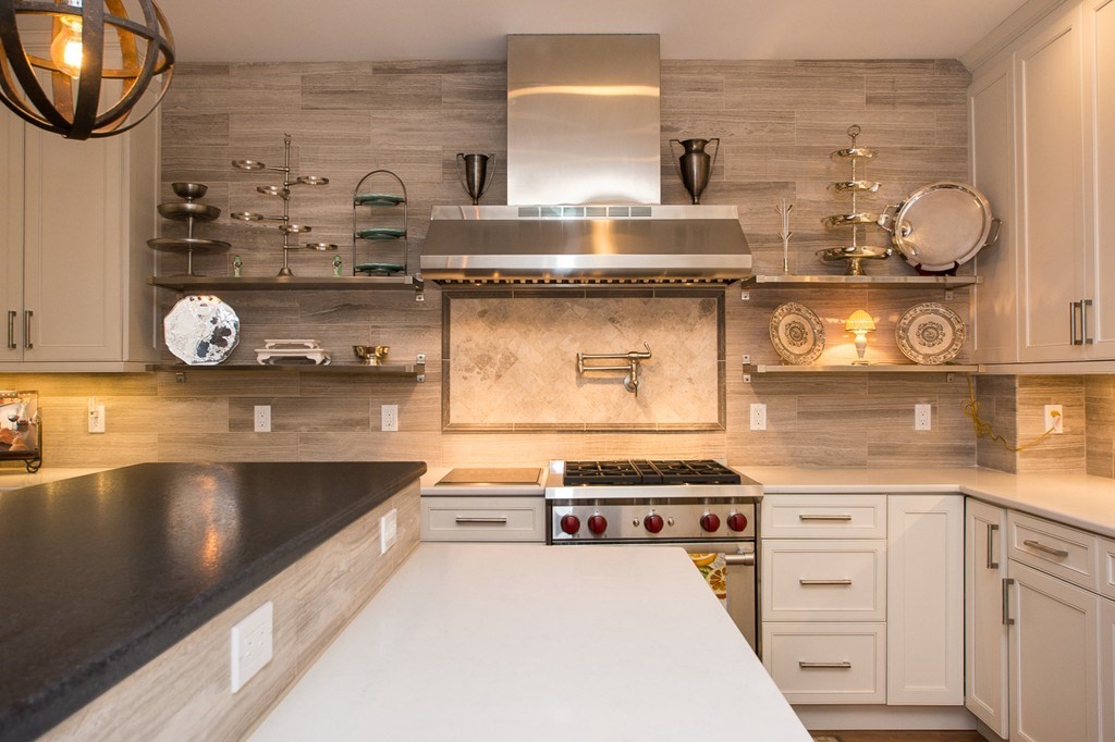 1 Winter Place, Unit 2 Boston, MA 02108 - Photo 4 of 17 a kitchen with granite countertop a stove and a sink