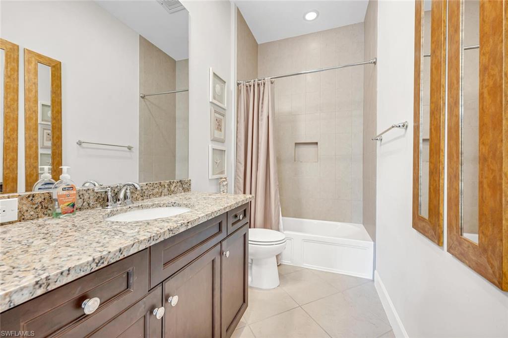 6553 Dominica Drive, Unit 101 Naples, FL 34113 - Photo 14 of 27 a bathroom with a granite countertop sink toilet and shower