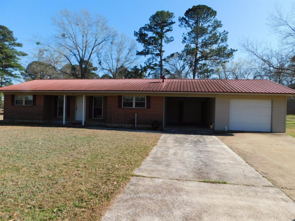 214 Springhill Airport Road Springhill, LA 71075 - Photo 1 of 32 a front view of a house with a garden