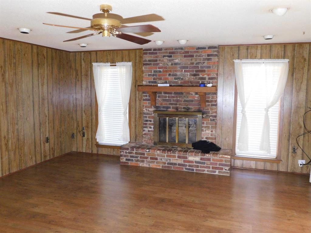 214 Springhill Airport Road Springhill, LA 71075 - Photo 12 of 32 a view of a livingroom with a fireplace window and wooden floor