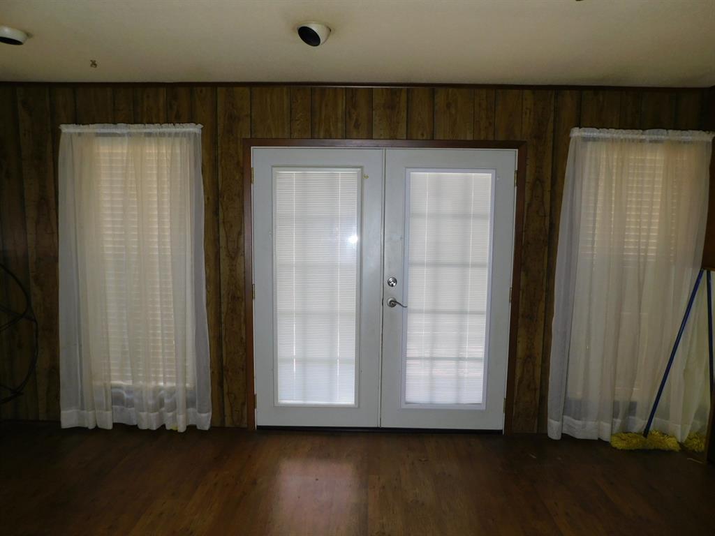 214 Springhill Airport Road Springhill, LA 71075 - Photo 14 of 32 an empty room with wooden floor and windows