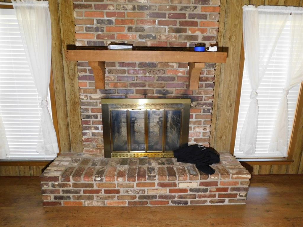 214 Springhill Airport Road Springhill, LA 71075 - Photo 15 of 32 a view of a fireplace with wooden floor
