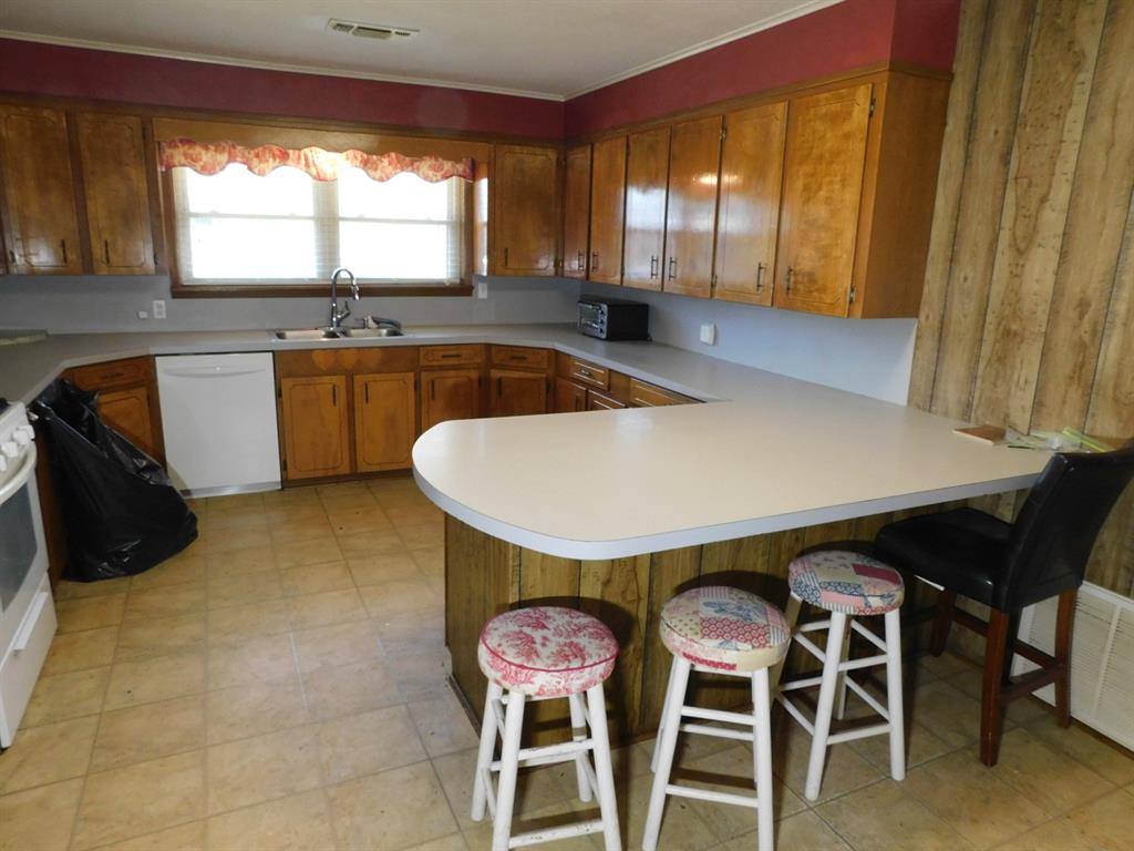 214 Springhill Airport Road Springhill, LA 71075 - Photo 23 of 32 a kitchen with a table and chairs in it