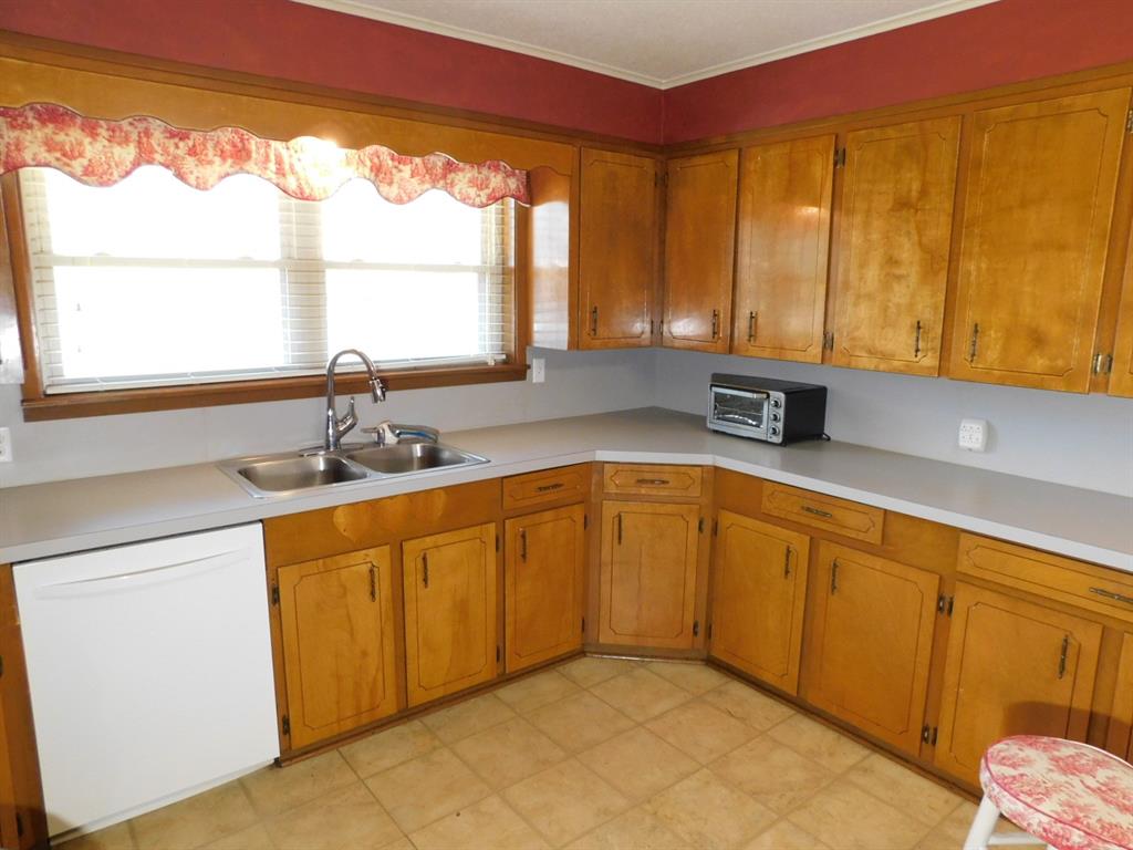 214 Springhill Airport Road Springhill, LA 71075 - Photo 24 of 32 a kitchen with stainless steel appliances a sink window and cabinets