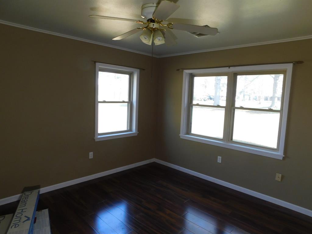 214 Springhill Airport Road Springhill, LA 71075 - Photo 30 of 32 a room with wooden floor and windows