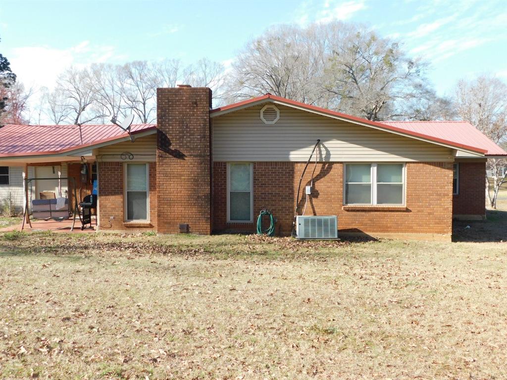 214 Springhill Airport Road Springhill, LA 71075 - Photo 9 of 32 a house with trees in the background