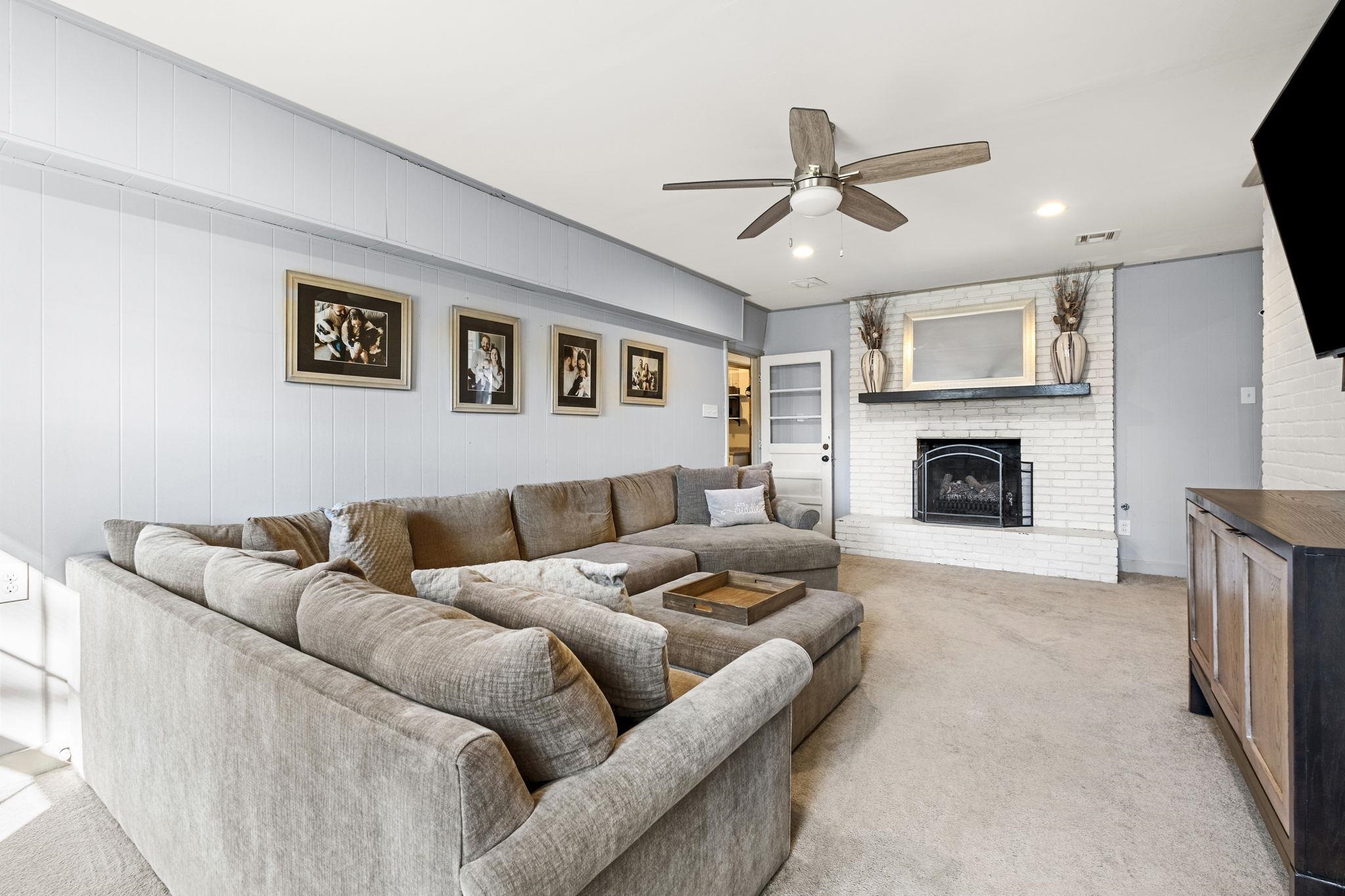 4120 Village Road Memphis, TN 38117 - Photo 14 of 28 Living room with a ceiling fan, light colored carpet, a brick fireplace, and recessed lighting