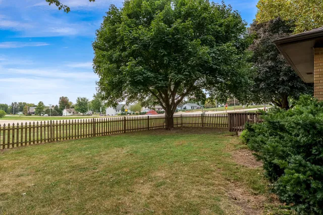 a view of a house with a backyard