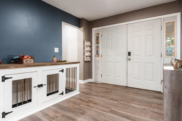a view of a livingroom with wooden floor and a fireplace
