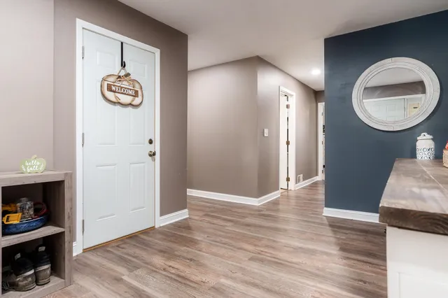 a bedroom with furniture and a mirror