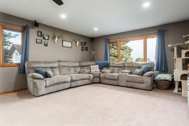 a living room with furniture and a chandelier